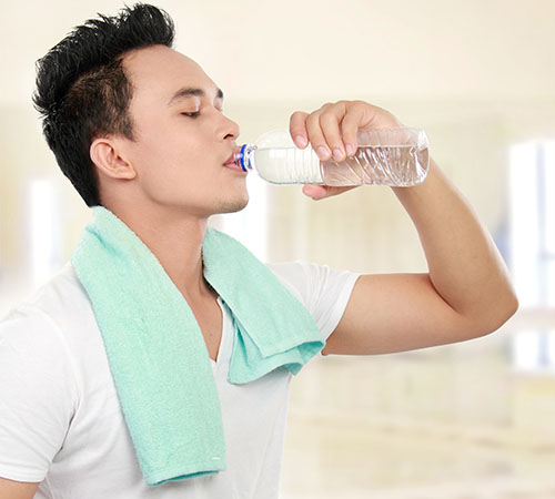 Young man drinking water